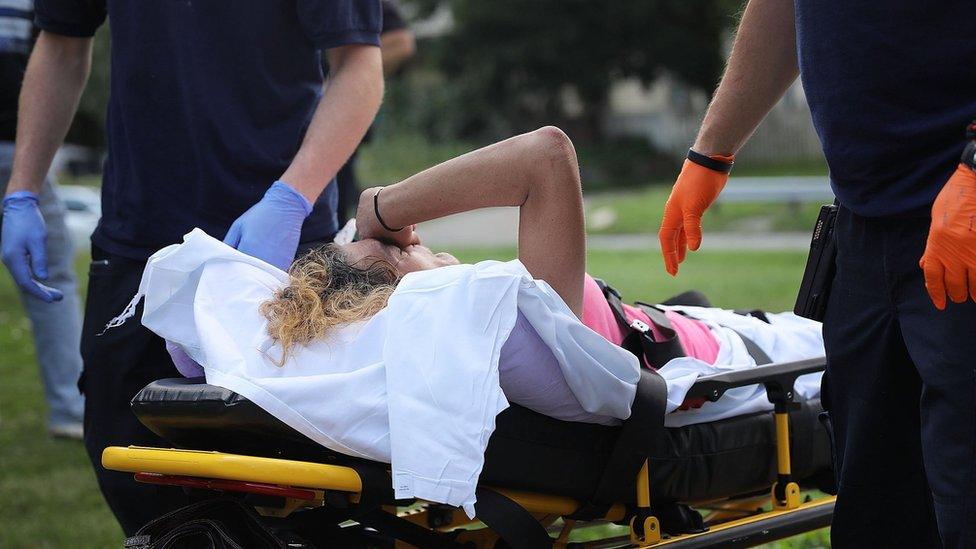 Medical workers and police treat a woman who has overdosed on heroin on July 14, 2017 in Warren, Ohio