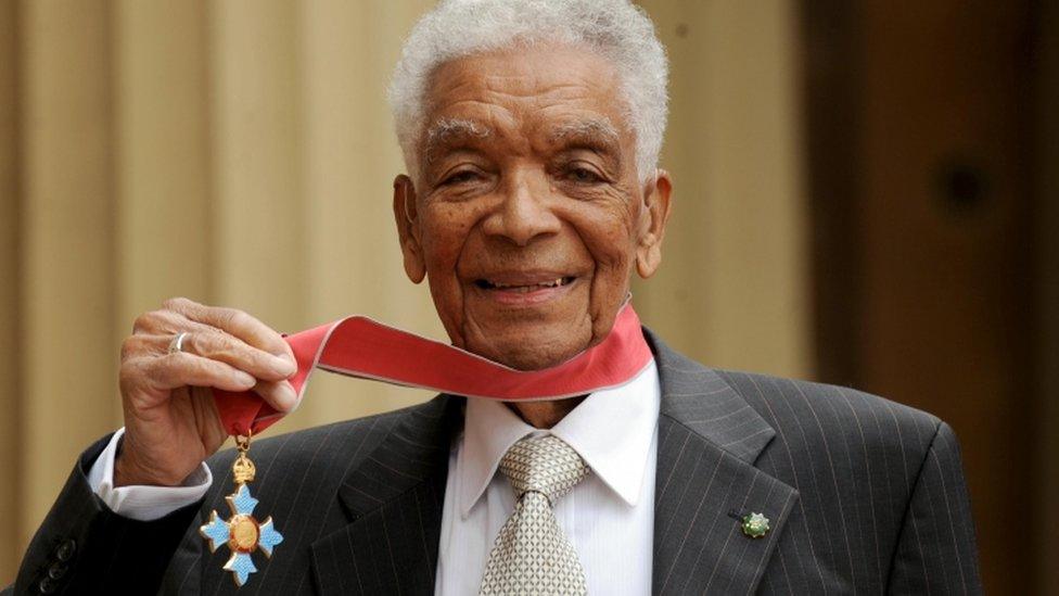 Earl Cameron outside Buckingham Palace with his CBE