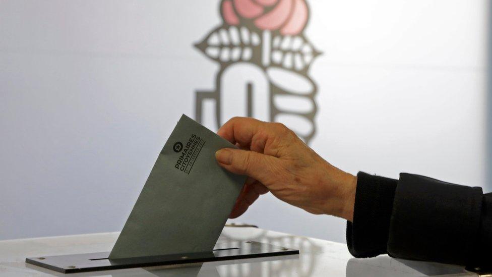 A woman votes in the second round of the French left's presidential primary election in Nice