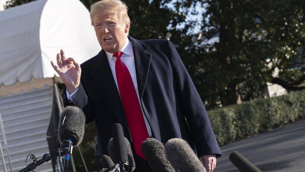 US President Donald Trump speaks to the media as he leaves the White House on his way to Camp David