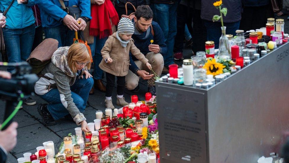 People mourn at the marketplace after yesterdays shooting on October 10, 2019 in Halle, Germany