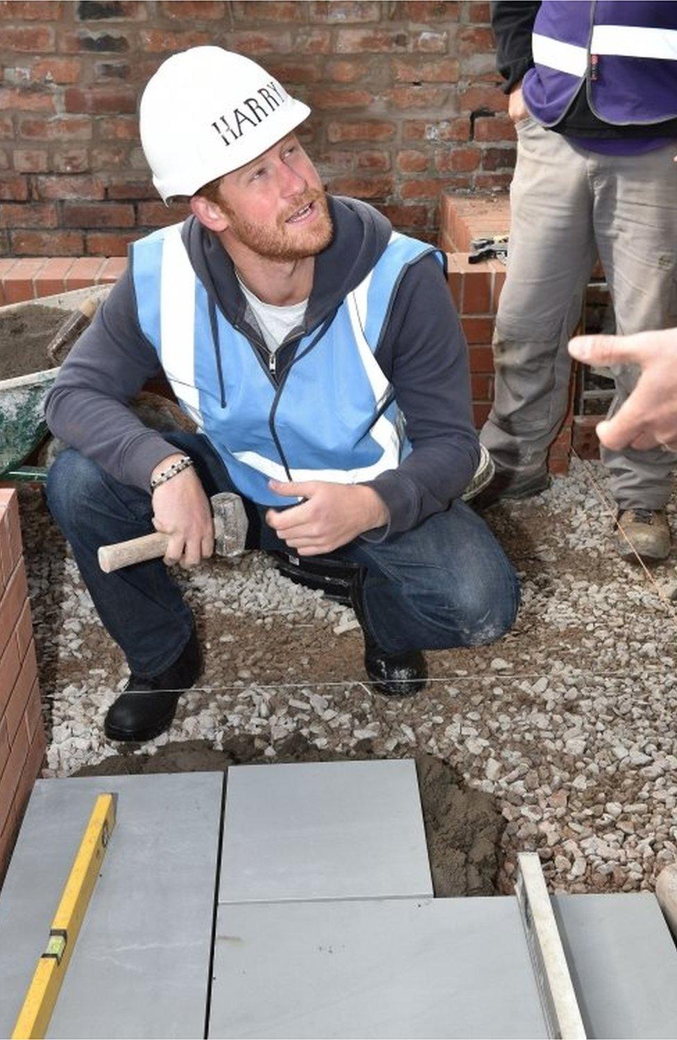 Prince Harry laying paving for DIY SOS