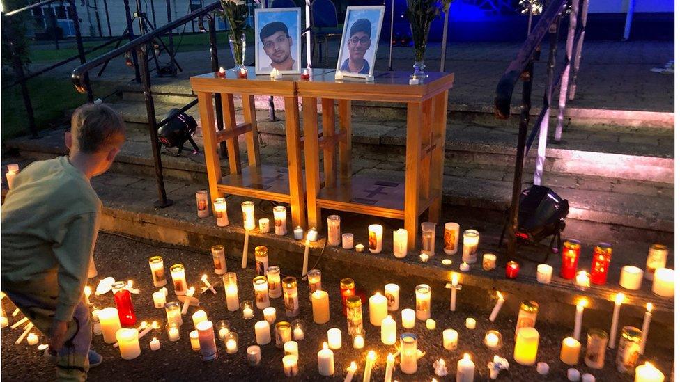 candles at vigil for Reuven Simon and Joseph Sebastian