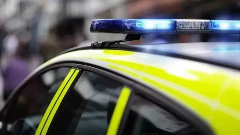 Top of a police car with blue lights on