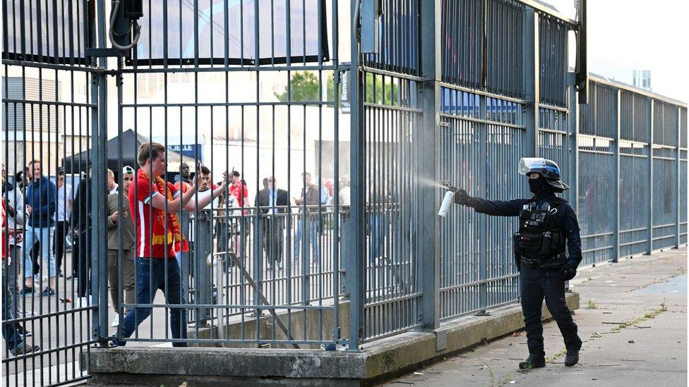 Police spray tear gas at Liverpool fans outside the stadium as fans struggle to enter prior to the UEFA Champions League final match between Liverpool FC and Real Madrid at Stade de France on May 28, 2022 in Paris, France. (Photo by Matthias Hangst/Getty Images)