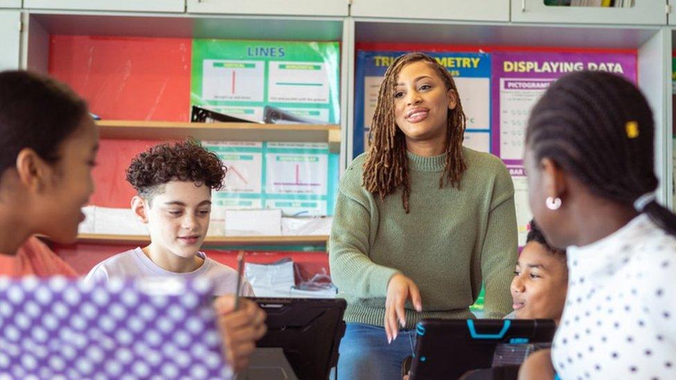 Stock image of a teacher and students in class