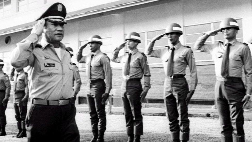 Manuel Noriega salutes troops at an undisclosed location in Panama, 1985