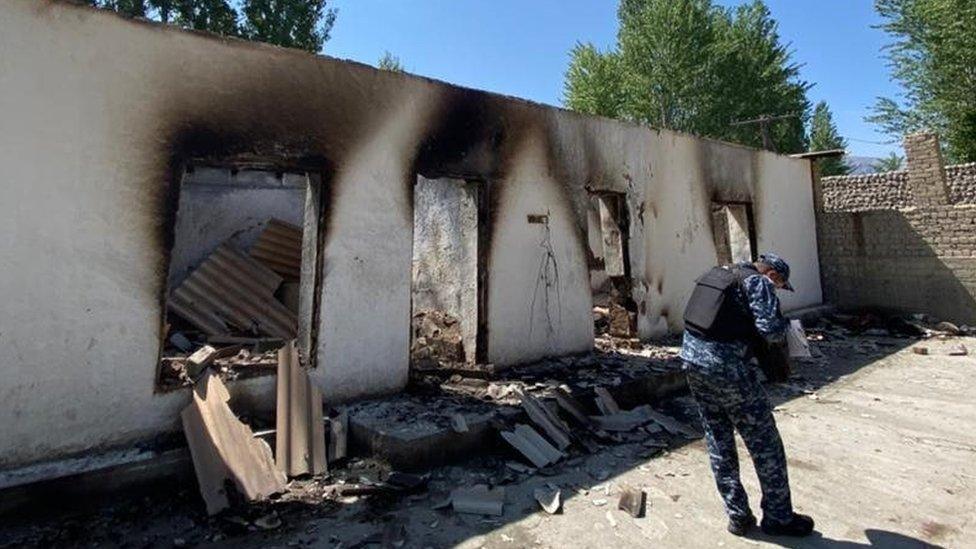 An official documents the damage to buildings in the area