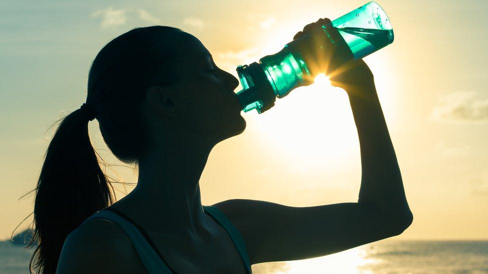 Woman drinking bottled water