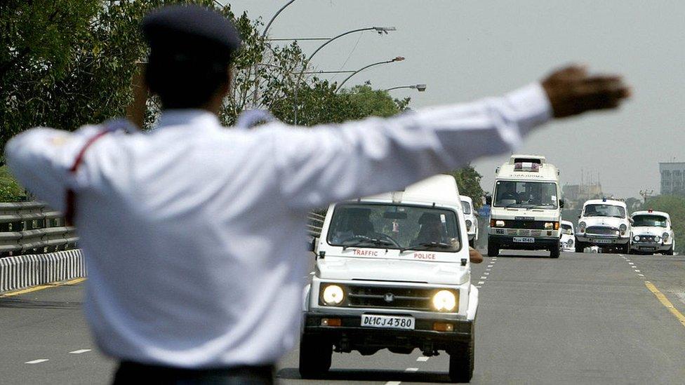 A policeman directing traffic in Delhi