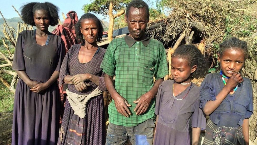 Admassie Mekonen (centre) with family and neighbours