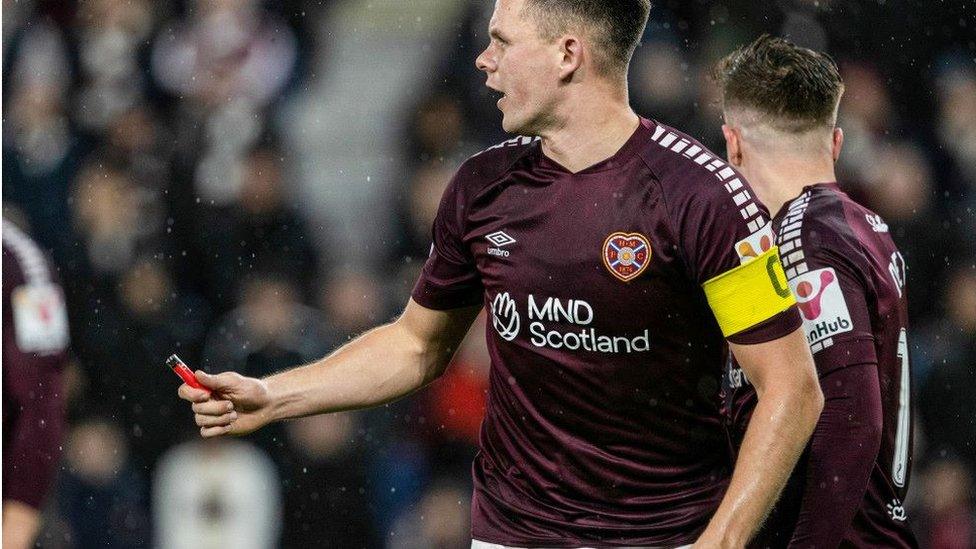 Lawrence Shankland holds a lighter that hit him during a match between Hearts and Hibs at Tynecastle last month