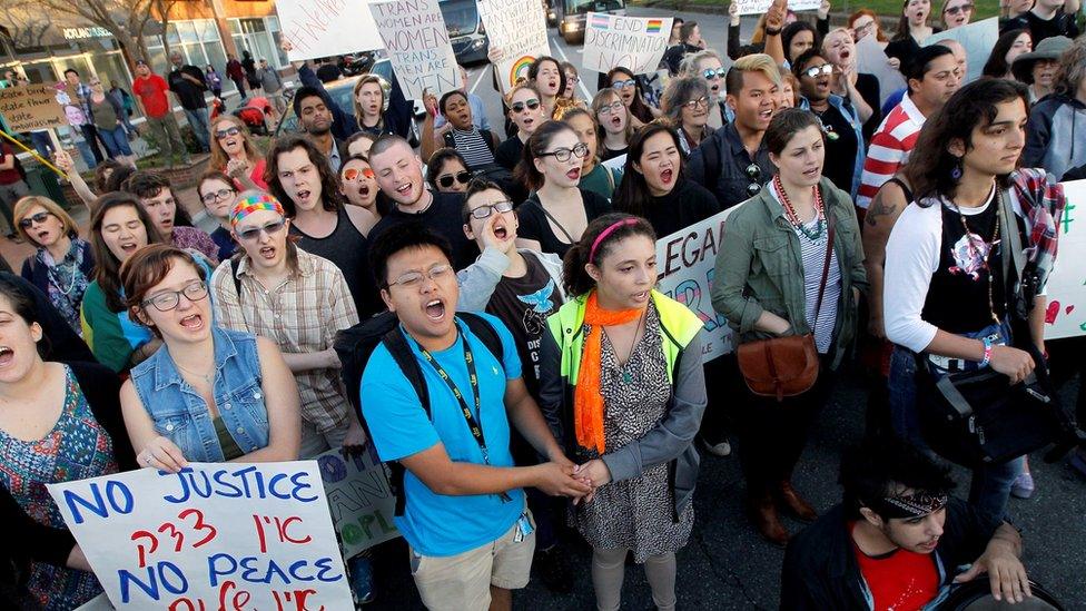 Protesters chant at the intersection of Franklin St. and Columbia St. where they formed a circled and stopped traffic for hours in Chapel Hill, N.C., Tuesday, March 29, 2016