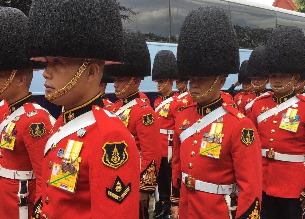 Soldiers dressed in ceremonial outfits gathering outside the Grand Palace in Bangkok on 14 October 2016