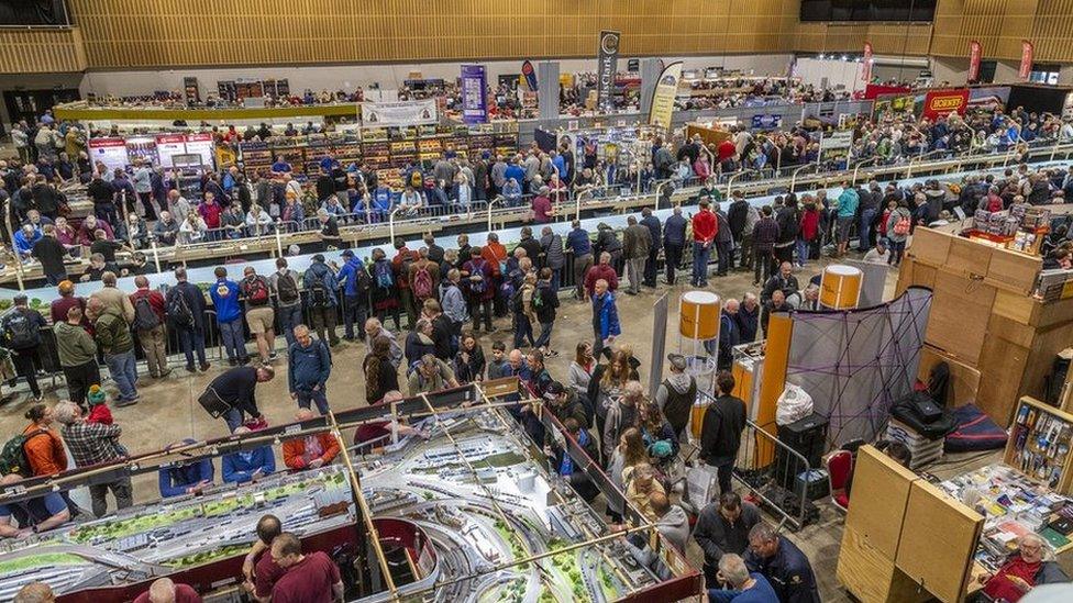 People at a model train exhibition