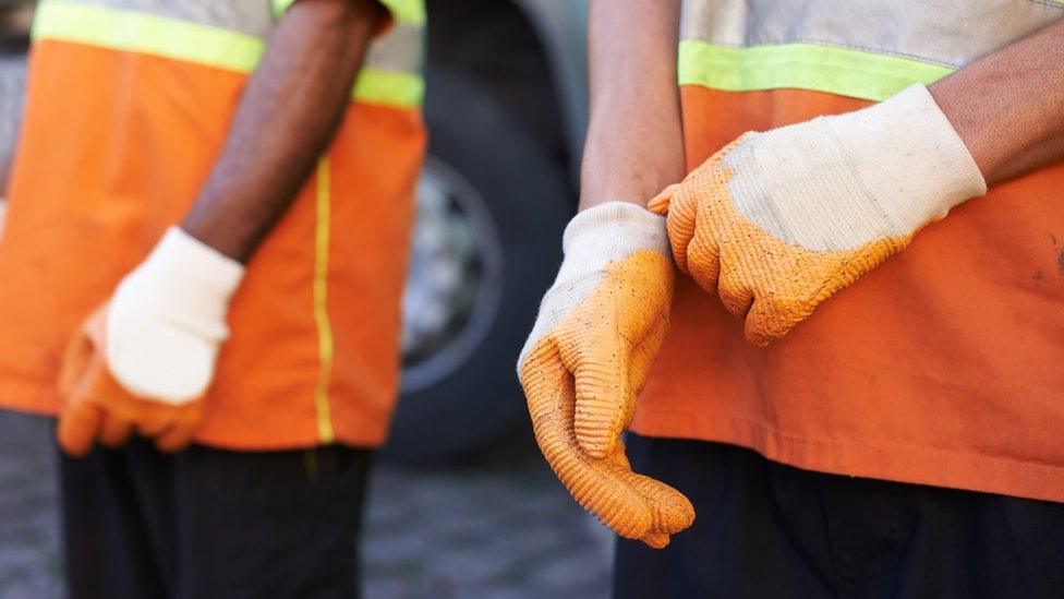 Bin men wearing gloves