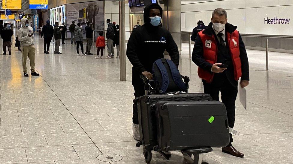 A man walks through arrivals at Heathrow