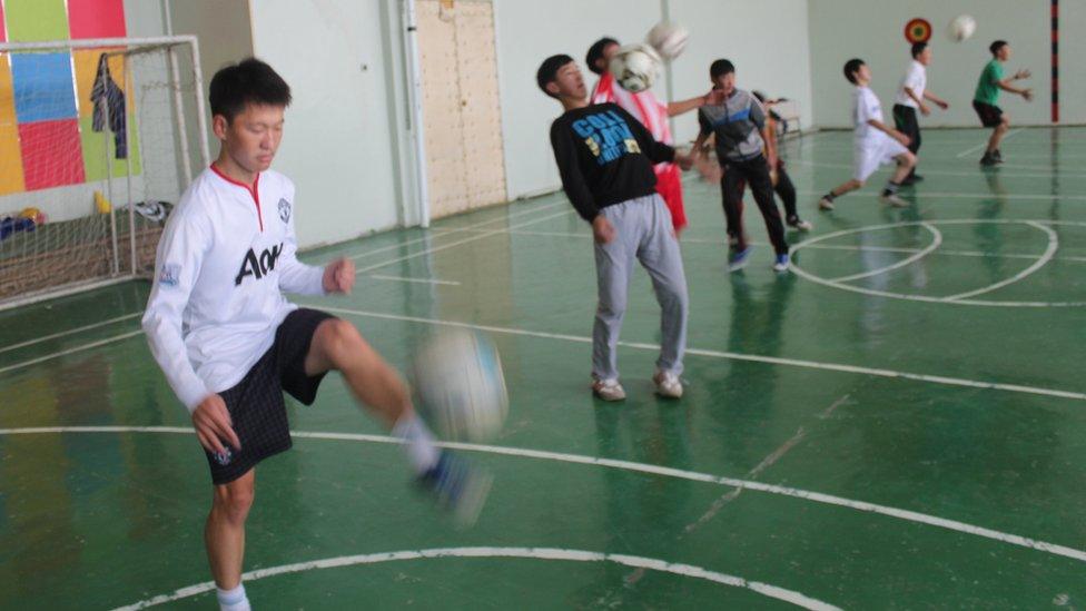 Ochiroo (in white Manchester United shirt) during a full session at the school gym where he trained alone