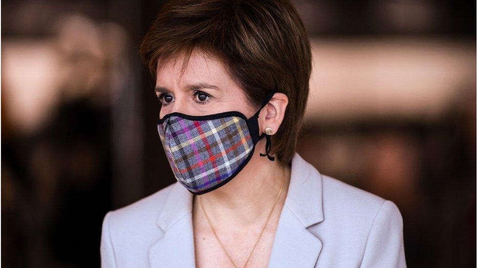 First Minister of Scotland Nicola Sturgeon wears a Tartan face mask as she visits New Look at Ford Kinaird Retail Park on June 26, 2020