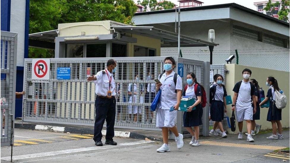 Students leave the River Valley High School compounds in Singapore on July 19, 2021, after a 13-year-old boy was found dead on the premises with multiple wounds, while a fellow student was arrested and an axe seized, police said.