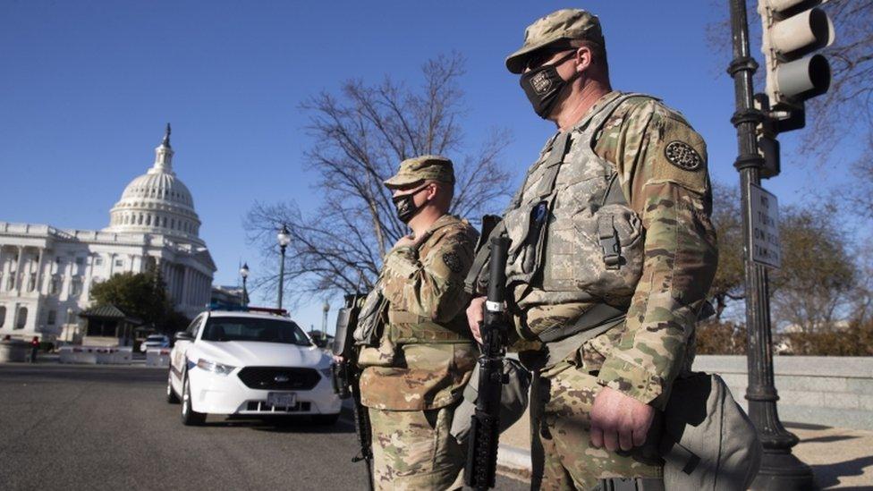 Members of the National Guard stand at the East Front of the US Capitol in Washington, DC