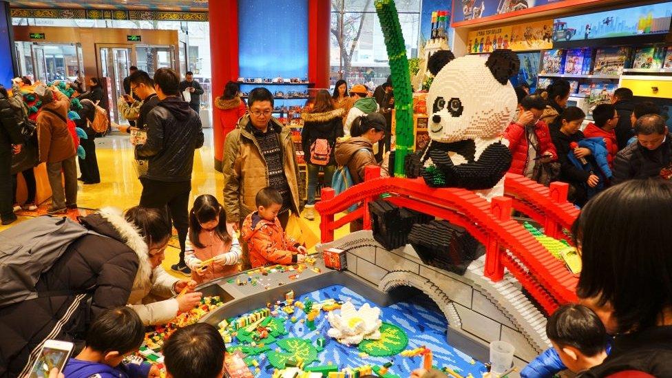 Shoppers look at a giant panda shaped decoration at the Lego flagship store at Wangfujing Street on February 23, 2019 in Beijing, China. Lego Group, the world's leading toy maker, unveiled its first flagship store in Beijing on Friday