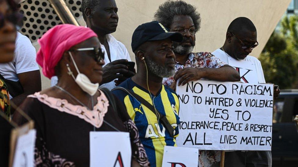 People hold a protest demanding justice for 39-year-old Nigerian street vendor Alika Ogorchukwu, who was killed in the seaside town of Civitanova Marche in Milan, Italy on August 06, 2022