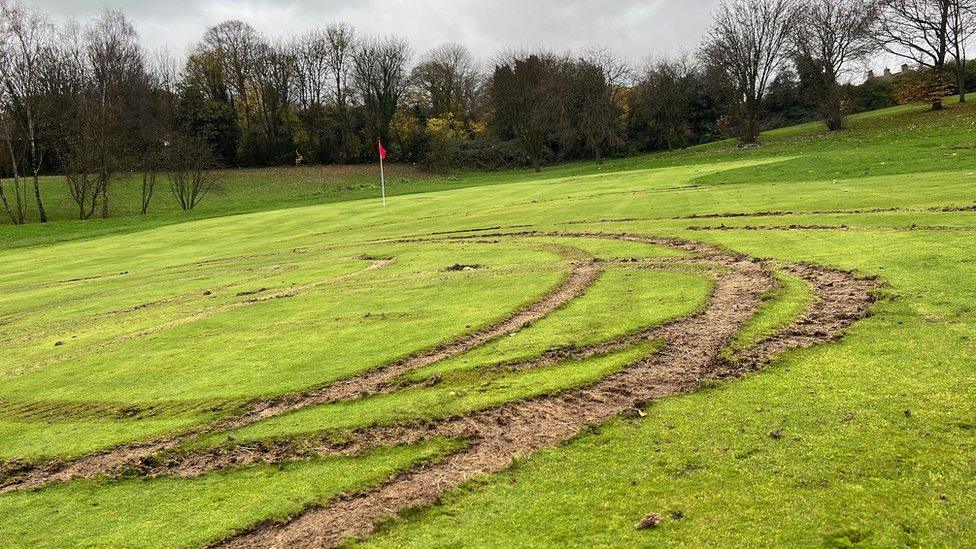 Tyre marks on golf green