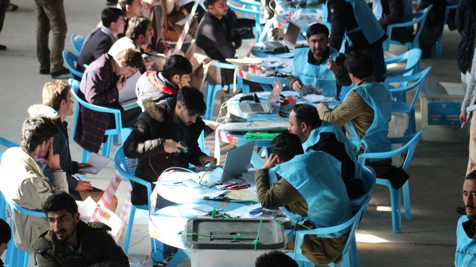 Workers of the Independent Election Commission (IEC) recounting ballot papers