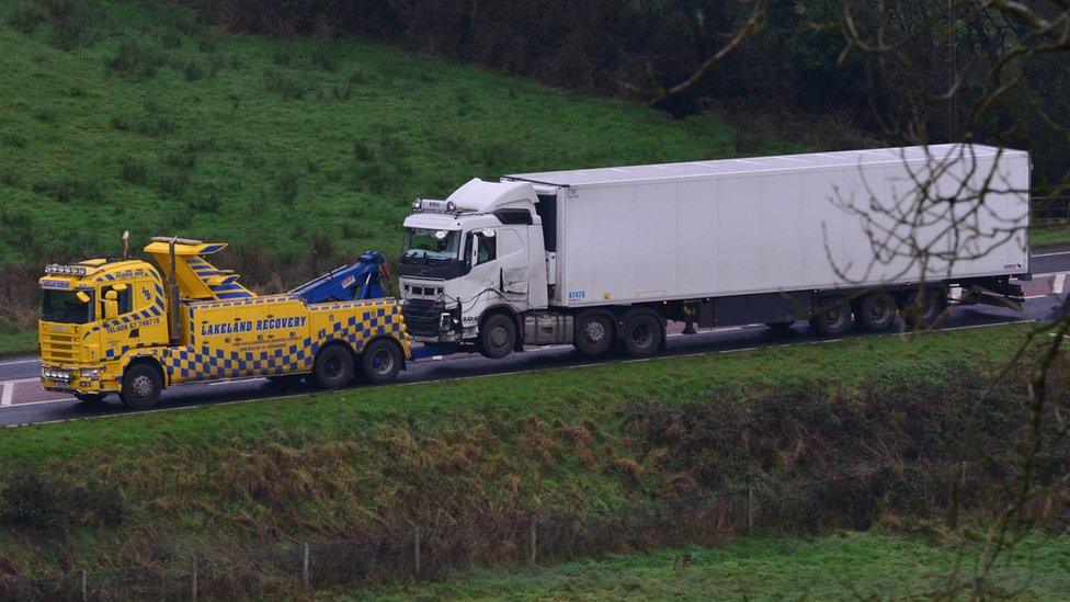 A recovery lorry tows the lorry that was involved in the crash away from the scene