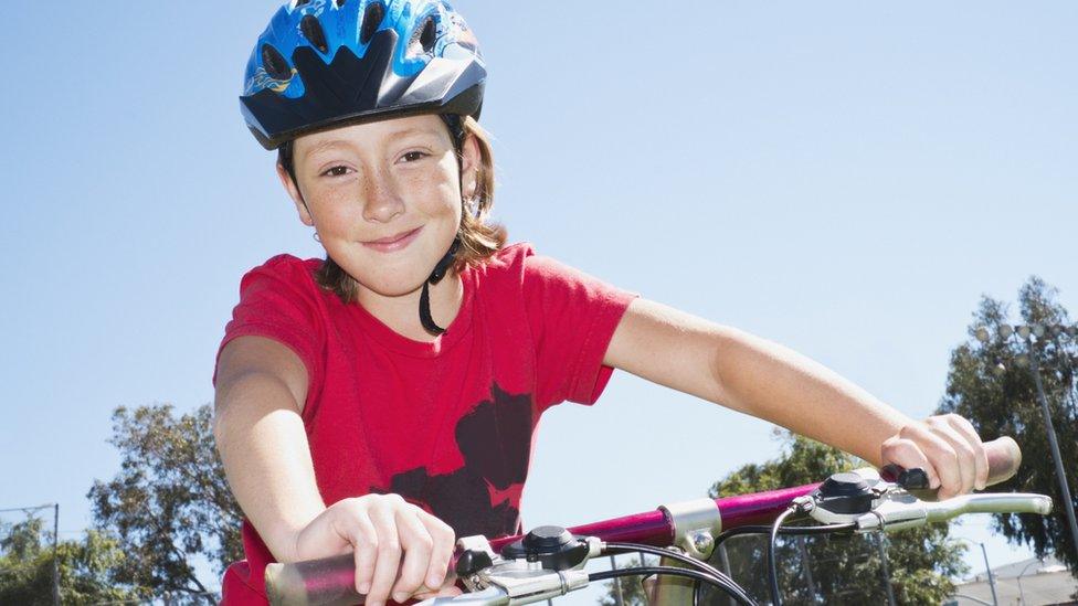 girl riding bicycle outdoors - stock photo