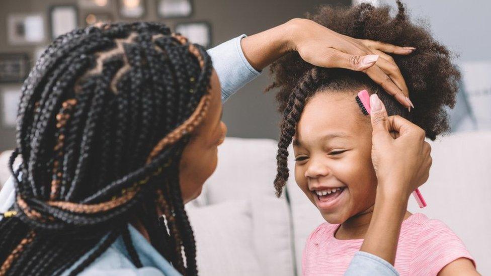 mum-styling-daughter's hair.