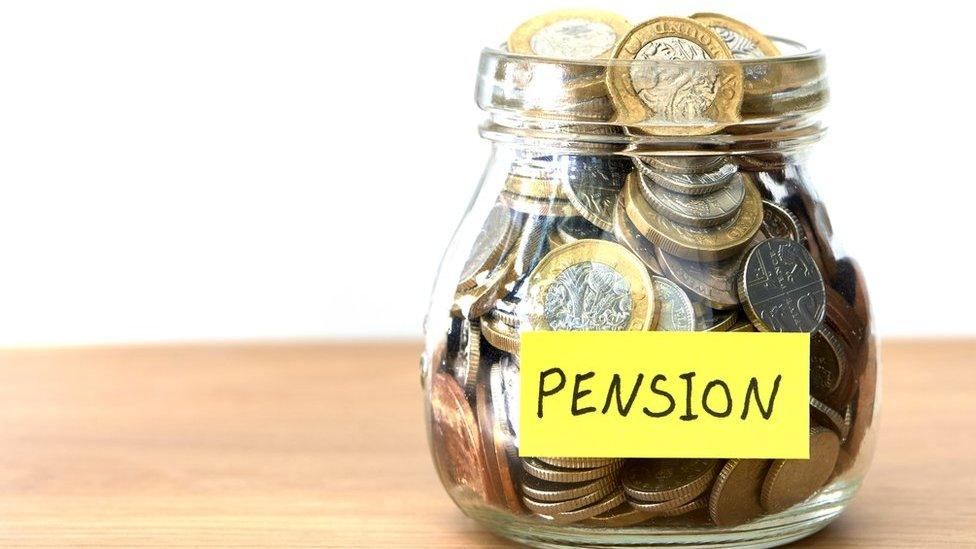 Money in a jar marked "pension"