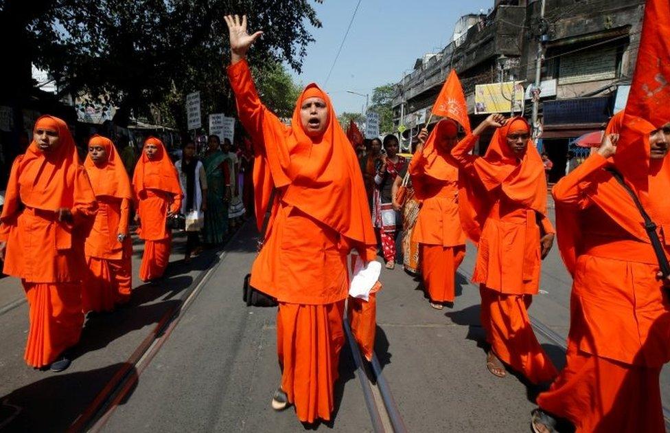 Hindu nuns shout slogans during a rally to mark the International Women's Day in Kolkata, India