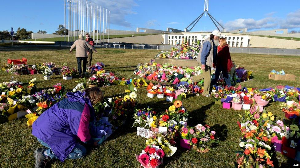 Anti-gay marriage campaigners lay flowers in front of the Australian Parliament