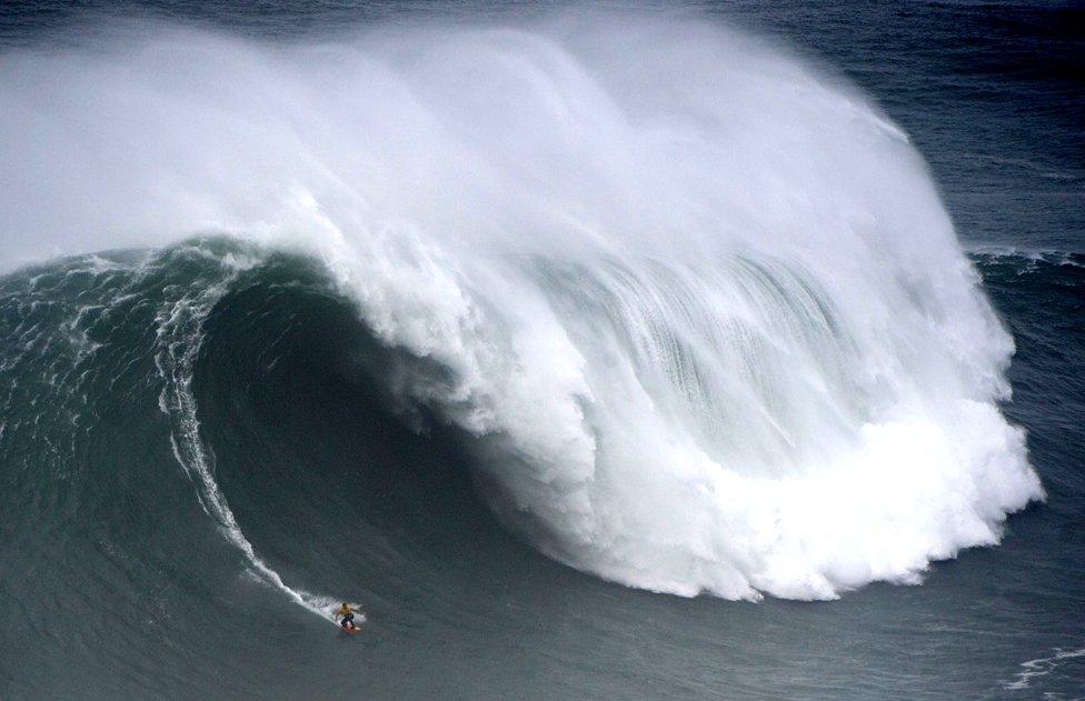 Spanish surfer Axier Muniain rides a wave