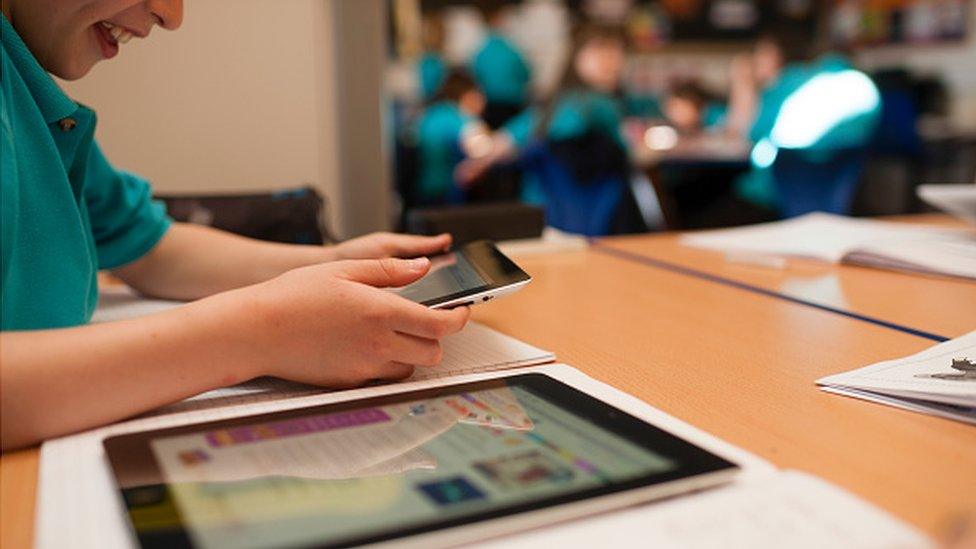 A schoolboy working on an iPad