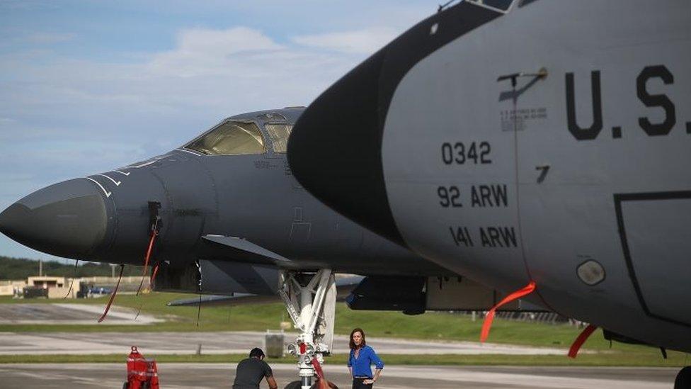 A US Air Force Rockwell B-1B Lancer (left) and a Boeing KC-135 Stratotanker (right) sit on the tarmac at Andersen Air Force base in Yigo, Guam (17 August 2017)