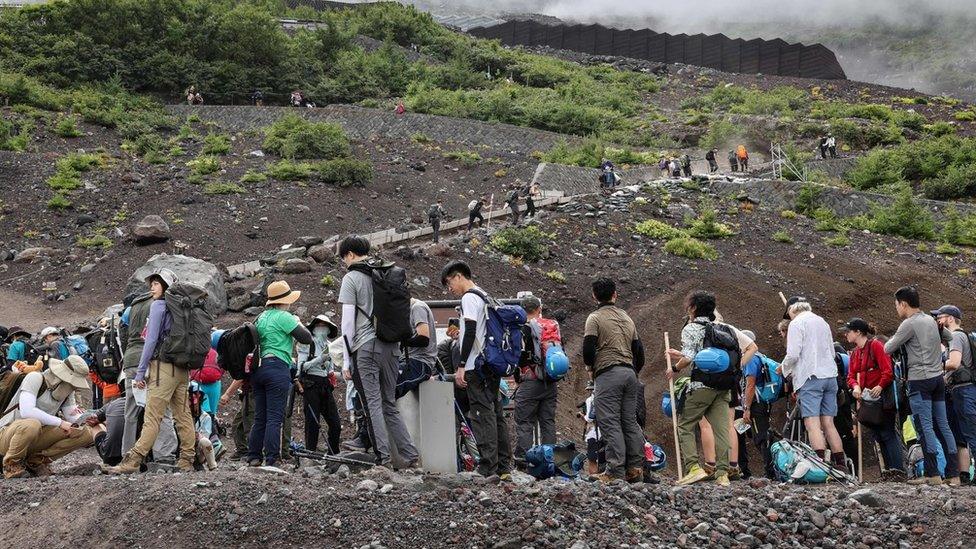 A queue of people climbing Mount Fuji