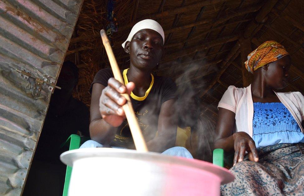 A woman stirs porridge