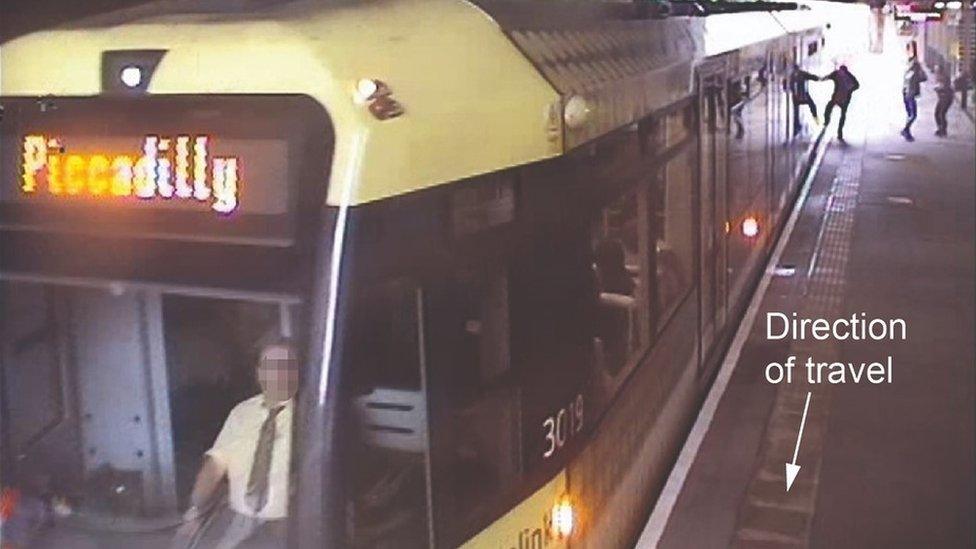 Man with hand caught in tram door