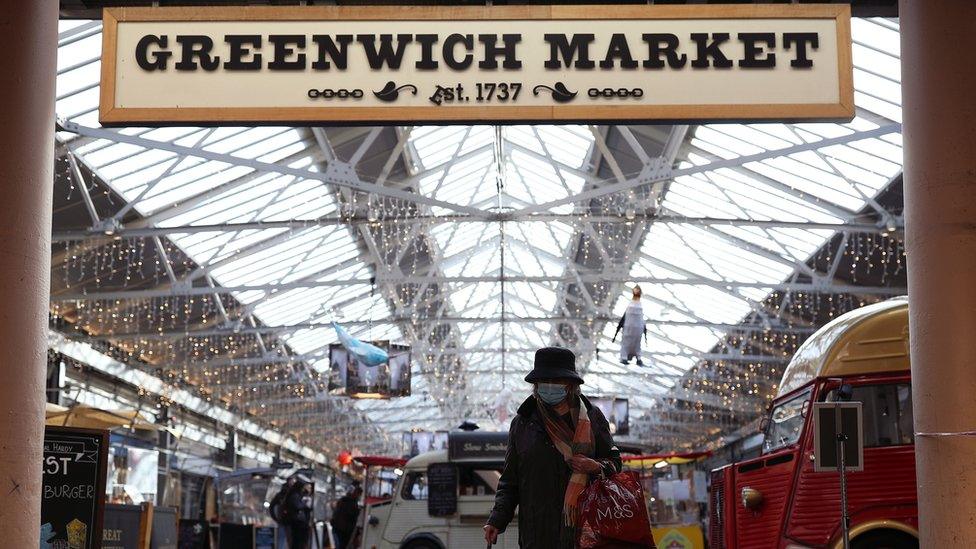 A woman wearing a face mask in Greenwich Market, London