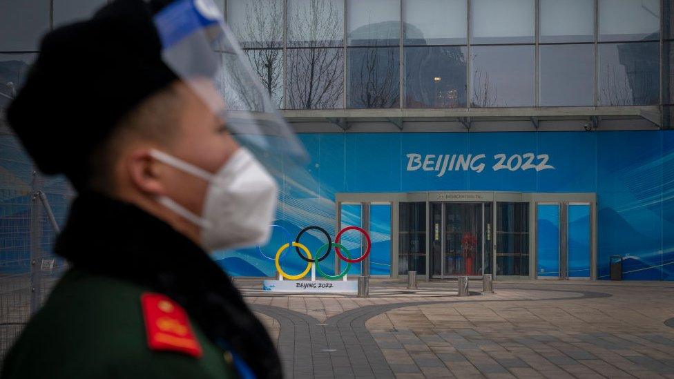 security standing outside the entrance to a beijing olympic venue