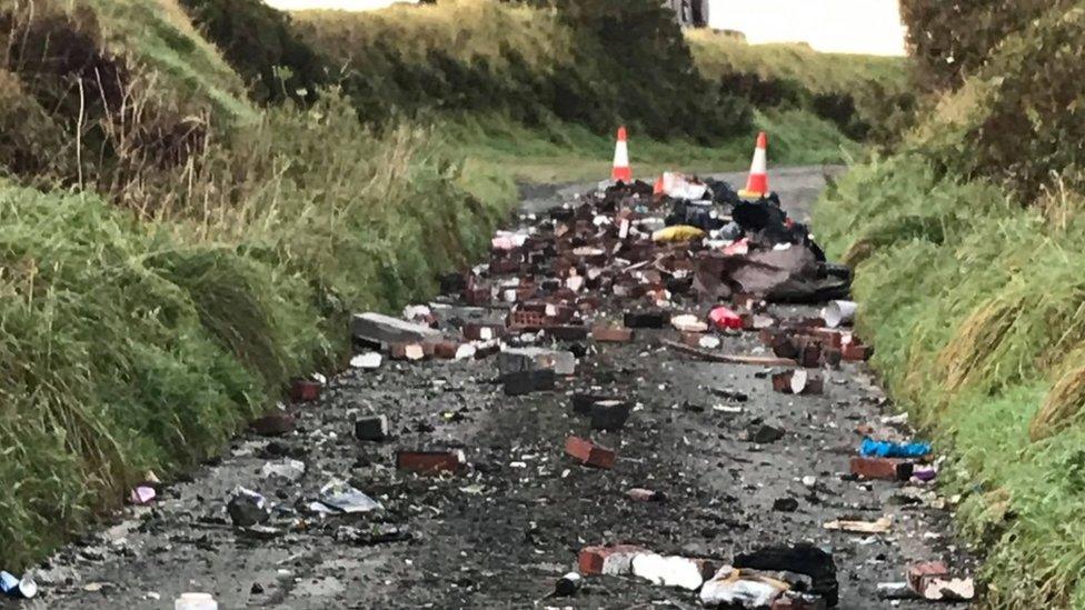 Fly-tipped rubbish on road