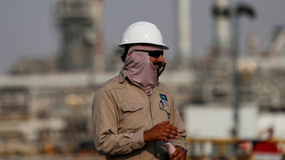 An employee looks on at Saudi Aramco oil facility in Abqaiq, Saudi Arabia.