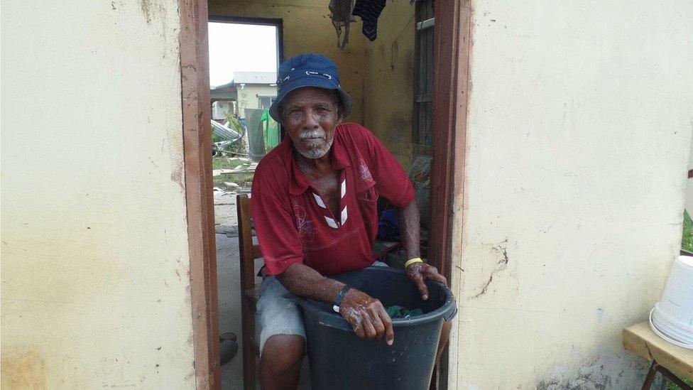 Manoah De Souza, 80, at work hand-washing his salvaged clothes