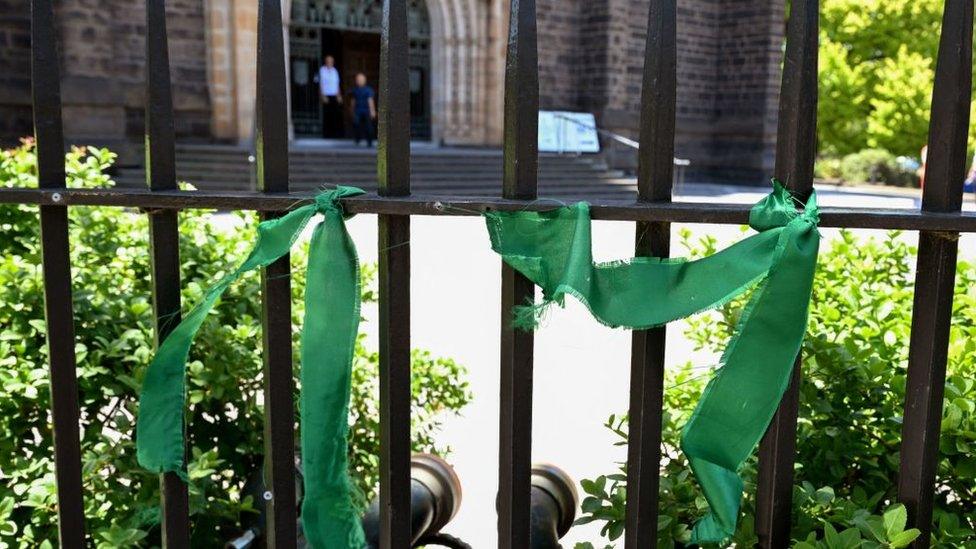 Green ribbons are tied to the fence around St Patrick's Cathedral