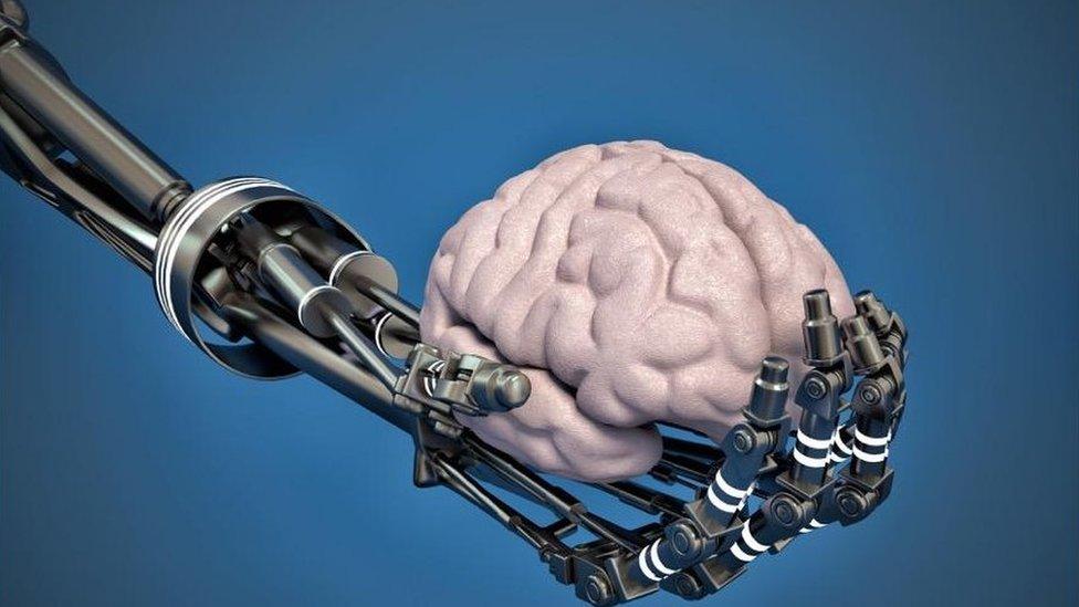 Robot hand holding brain