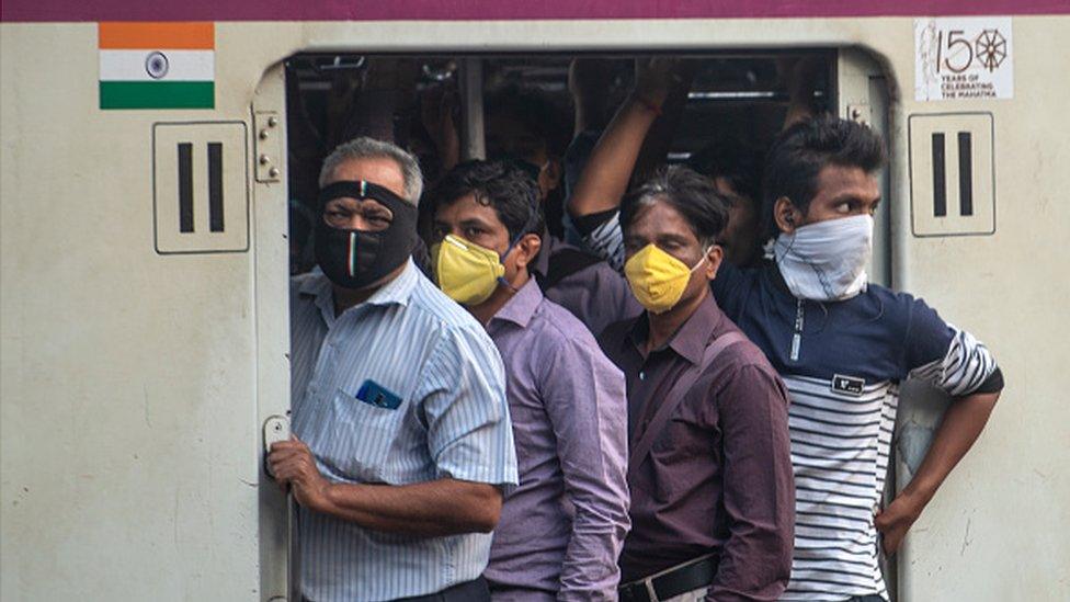 Passengers on a train in Mumbai