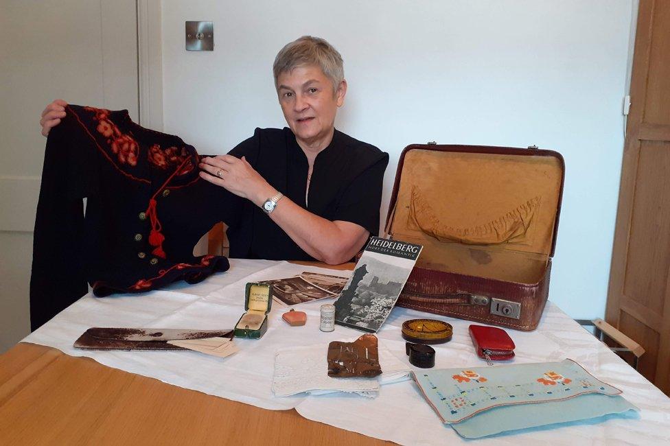 Judith Rhodes with her mother's suitcase and some of the belongings she brought with her